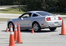 Mustang driving around cones