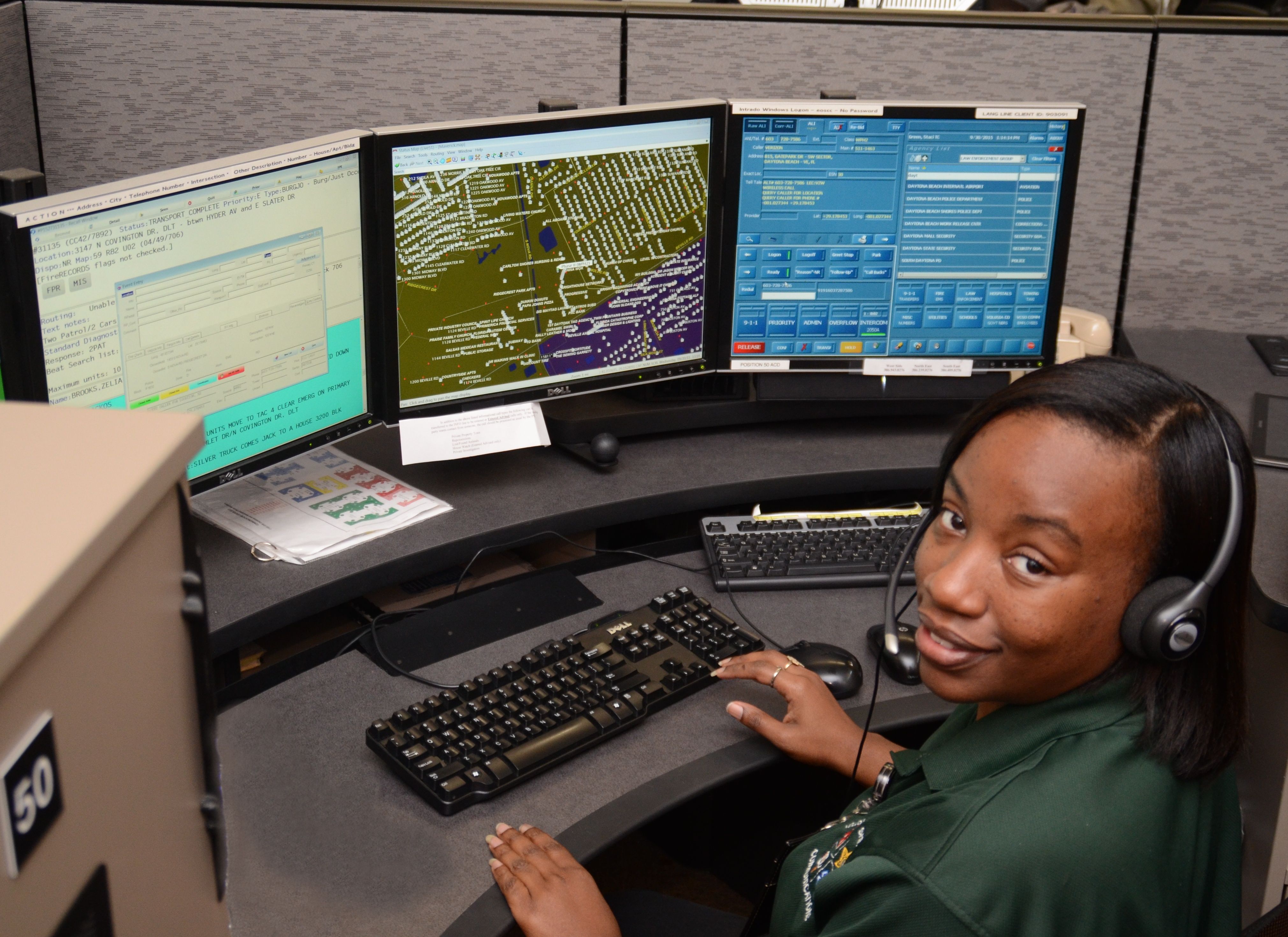 911 Operator in front of computer monitors